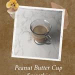 Peanut Butter Cup Smoothie in a glass mug on a white marble background.